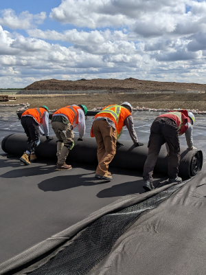 Installers unrolling some HydraNet Geocomposite